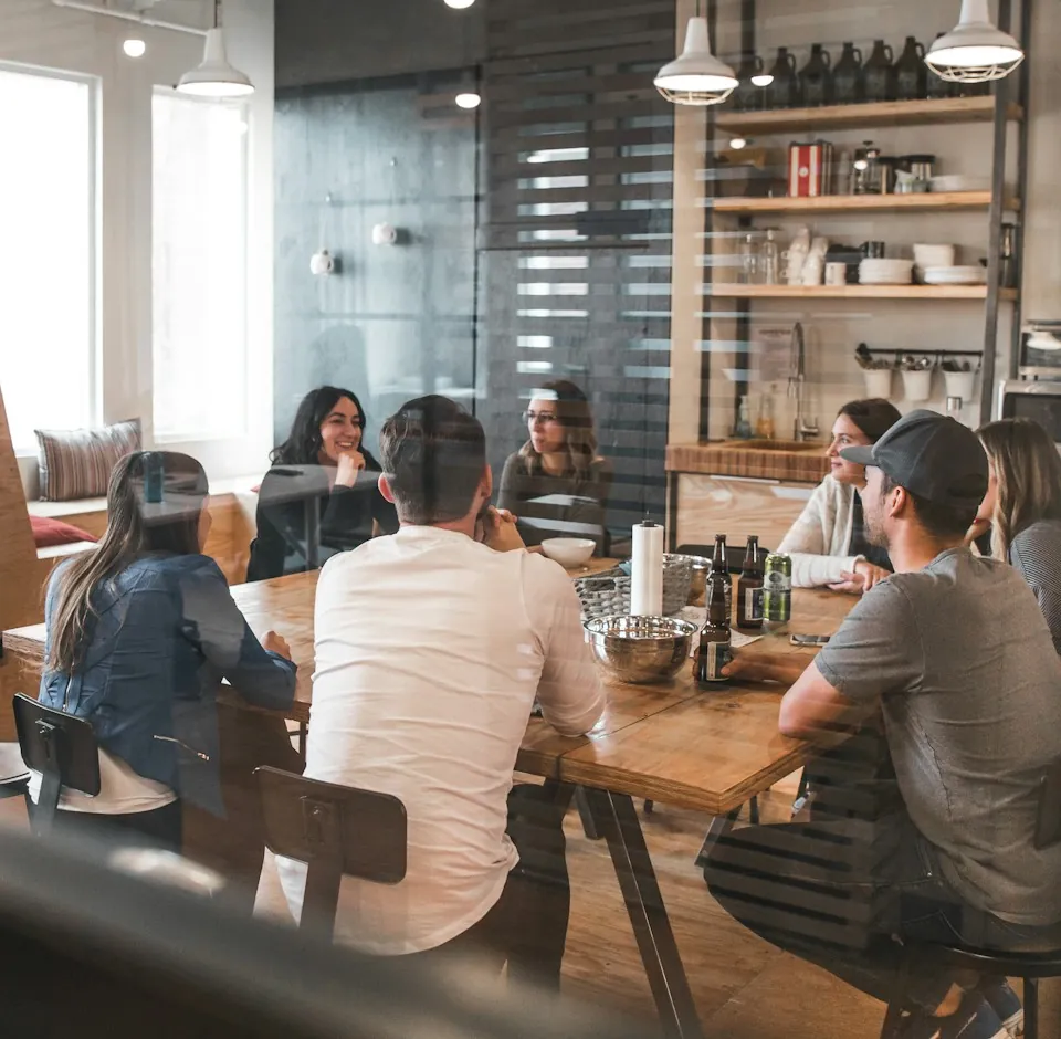 A team in conversation at a large wooden table